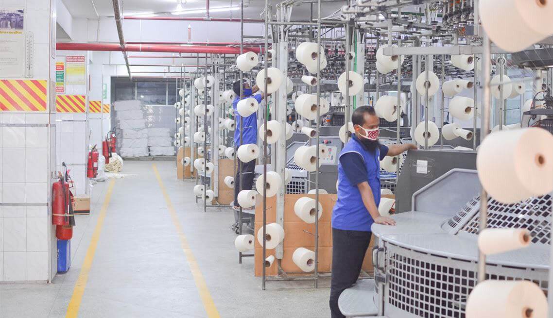 Rows of sewing machines on the factory floor